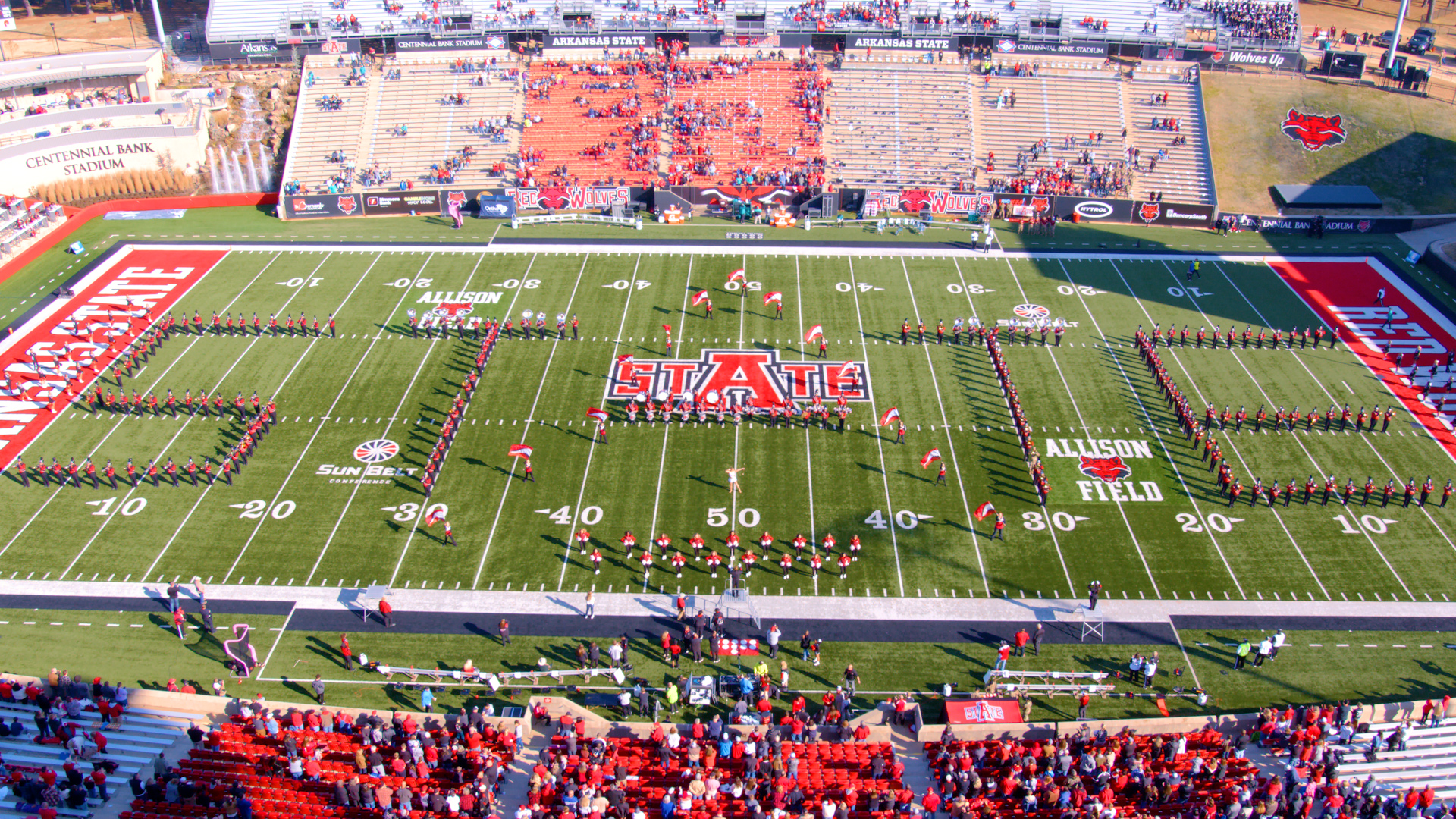 Marching Band in the stadium spelling out STATE